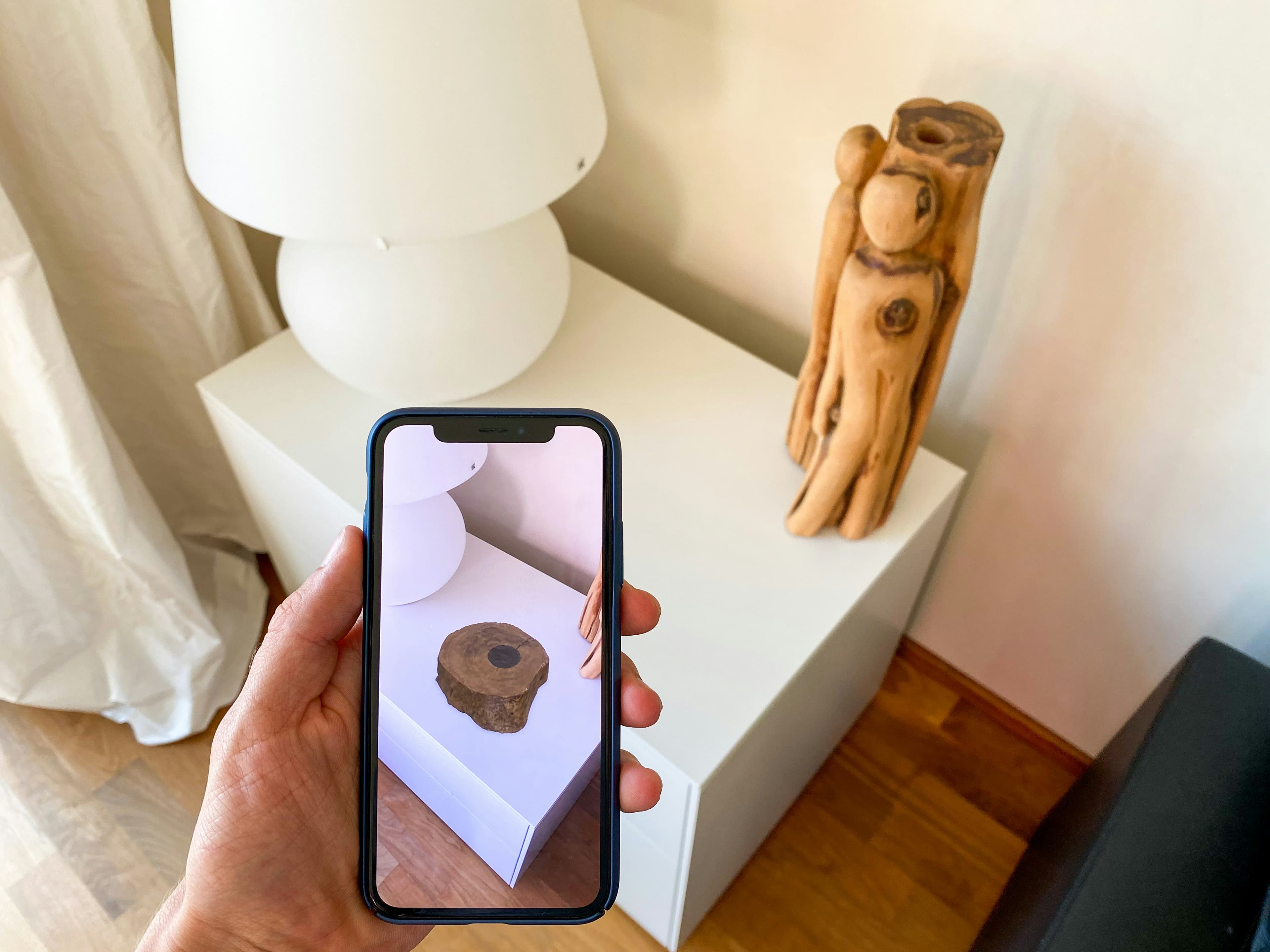 Phone displaying AR product view in real environment